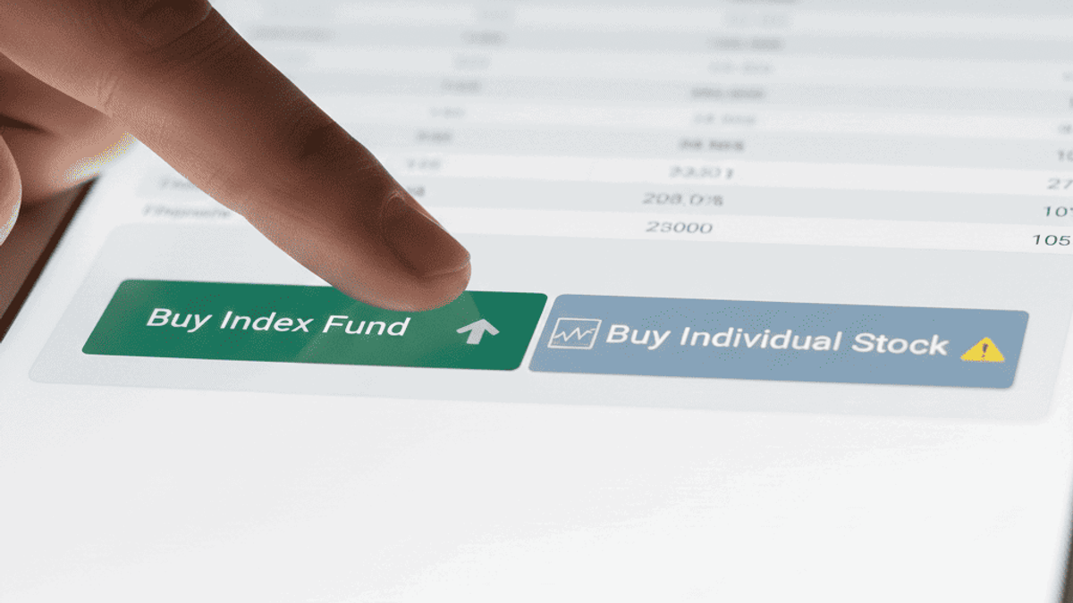 A person's hand is hovering over two buttons on a modern financial app interface. One button says "Buy Index Fund" with a simple, green upward arrow. The other says "Buy Individual Stock" with a more complex graph icon and a small warning symbol. The background is blurred, showing a spreadsheet.