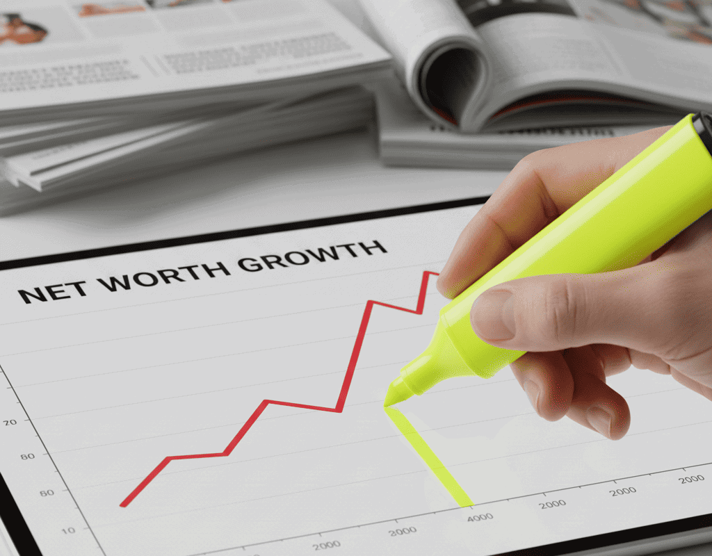 A close-up of a hand using a highlighter to mark a line graph that is sharply trending upwards, symbolizing positive Net Worth growth. The graph is displayed on a tablet, with blurred investment statements in the background.