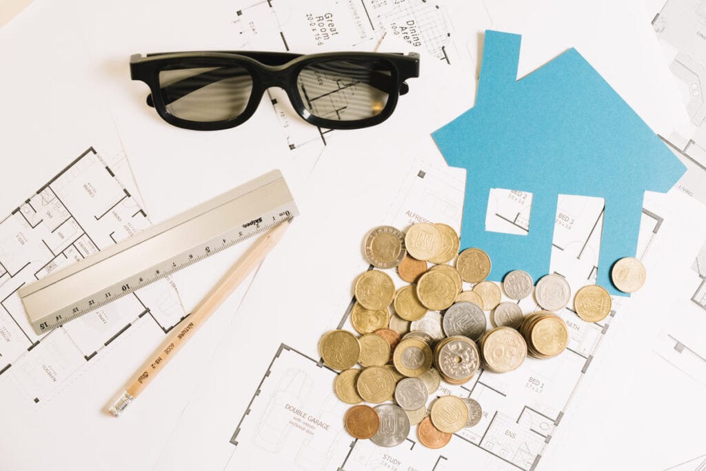 credit house blueprint coins flat lay.png