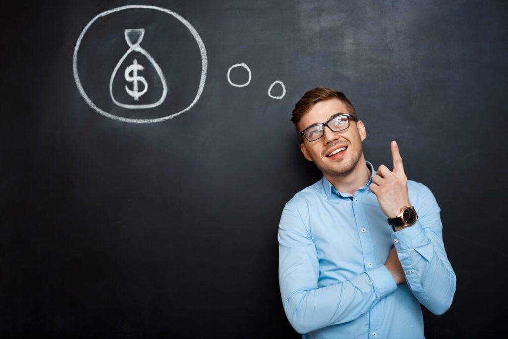 financial confidence illustrated by a smiling man pointing upward while imagining a money bag symbol on a chalkboard, representing clarity, planning, and confidence in personal financial decisions
